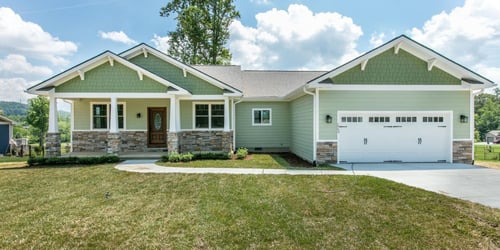 A pre-built spec home from the outside, painted green