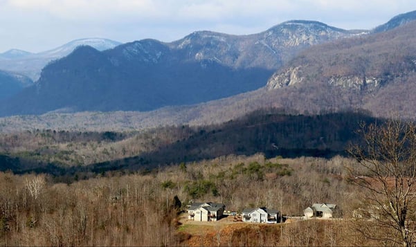 A view of homes in the distance nestled in the Blue Ridge Mountains