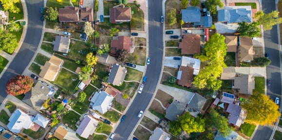 A birds-eye view of many homes in a neighborhood.