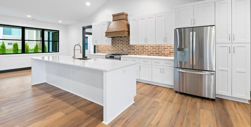 a clean modern farmhouse style home kitchen with a wide open area to cook