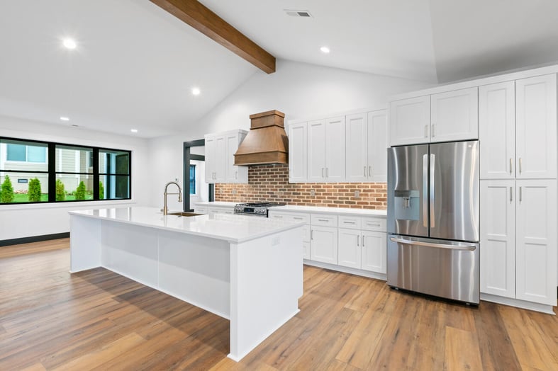 A wide open floor plan connects a kitchen to a living room, making a house feel bigger.