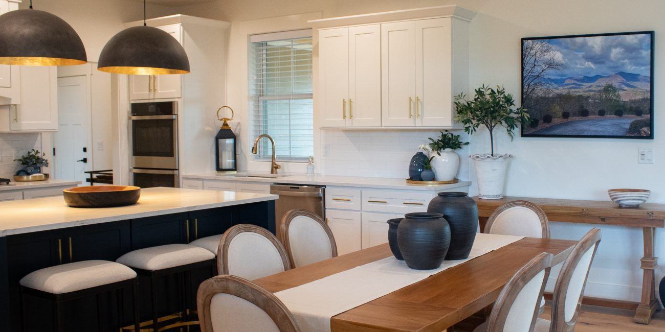 A clean dining room and kitchen in a home that's well-organized.