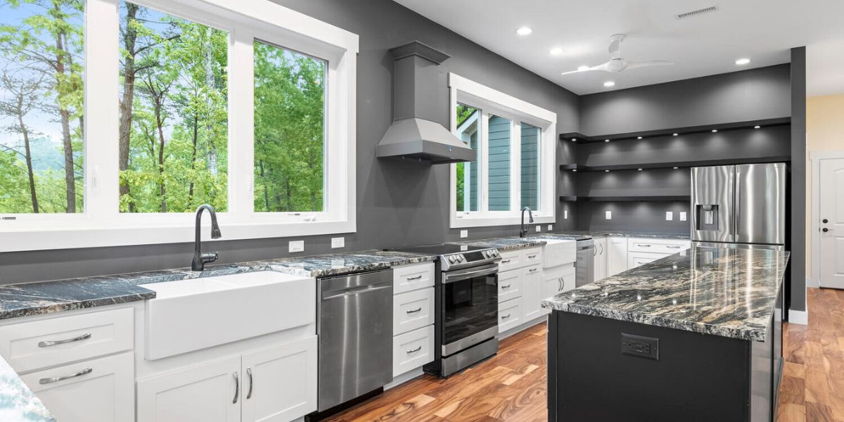 A fully decked out custom kitchen with a deep grey and white color scheme in a custom built home in the mountains